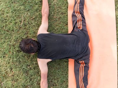 Detail of a stretching exercise on a mat